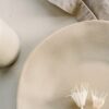a white plate with two white flowers on it