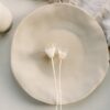 a white plate with two white flowers on it