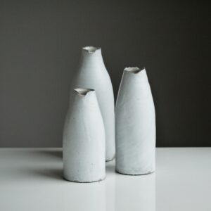 three white vases on table