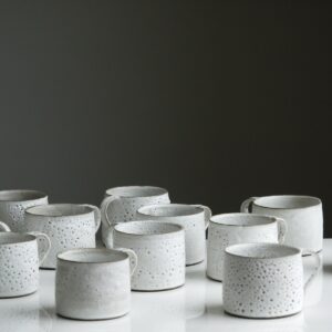 white ceramic mug lot on white surface