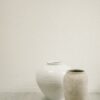 a couple of vases on a counter