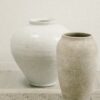 a couple of vases on a counter
