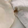 a white plate sitting on top of a white table